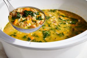 Slowcooker Bean Kale and Barley Soup in a ladle