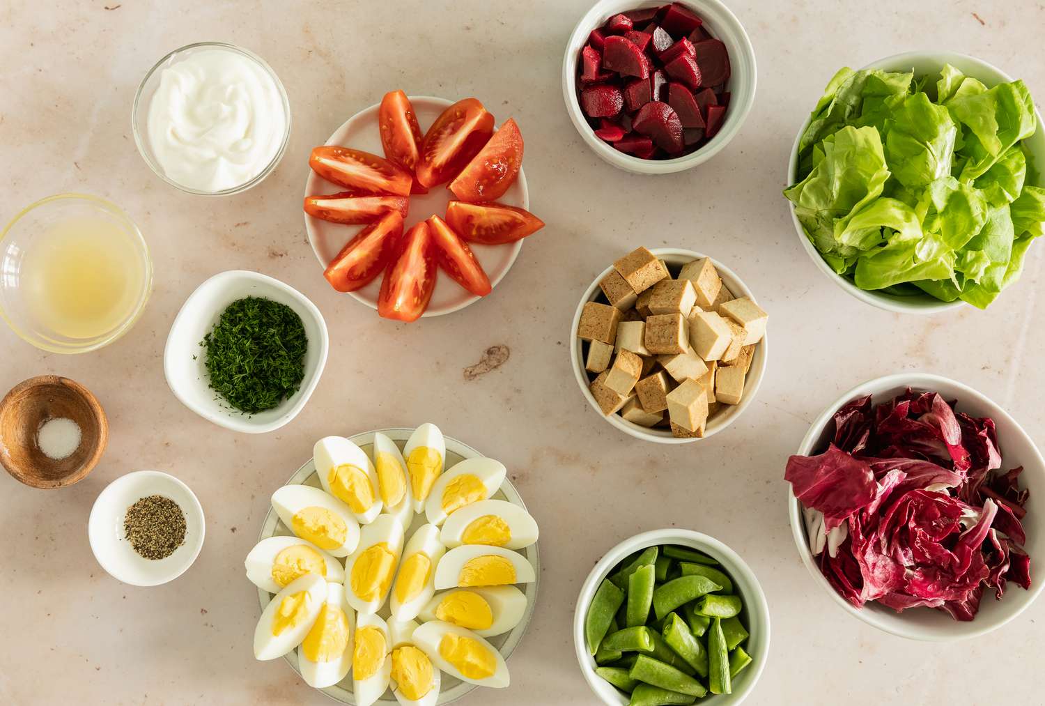 Overhead view of a ingredients in various bowls for Composed Salad with Pickled Beets & Smoked Tofu recipe