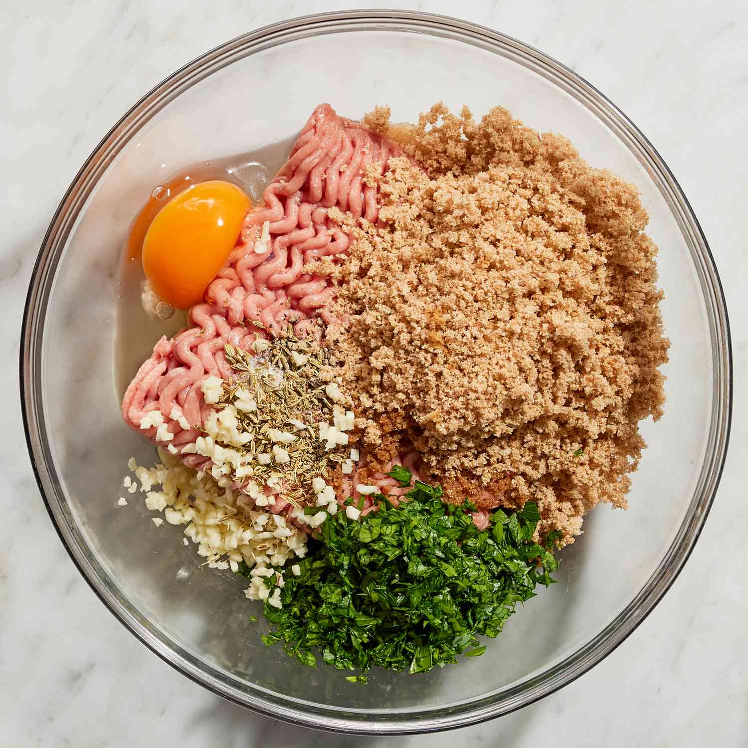 Ingredients for the Italian wedding soup recipe in a mixing bowl