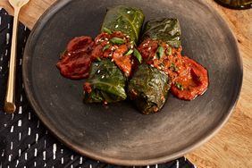 2 Stuffed Collard Greens with Mamba 9 Sauce on a plate