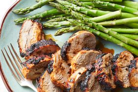 air-fryer pork tenderloin on a plate with asparagus