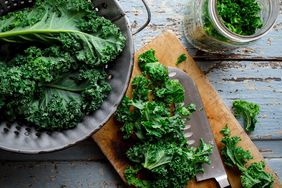 Colander and cutting board with kale