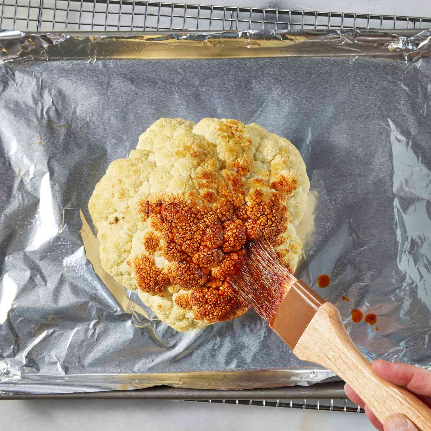 a step to make the Whole Roasted Cauliflower with Whipped Feta & Pomegranate
