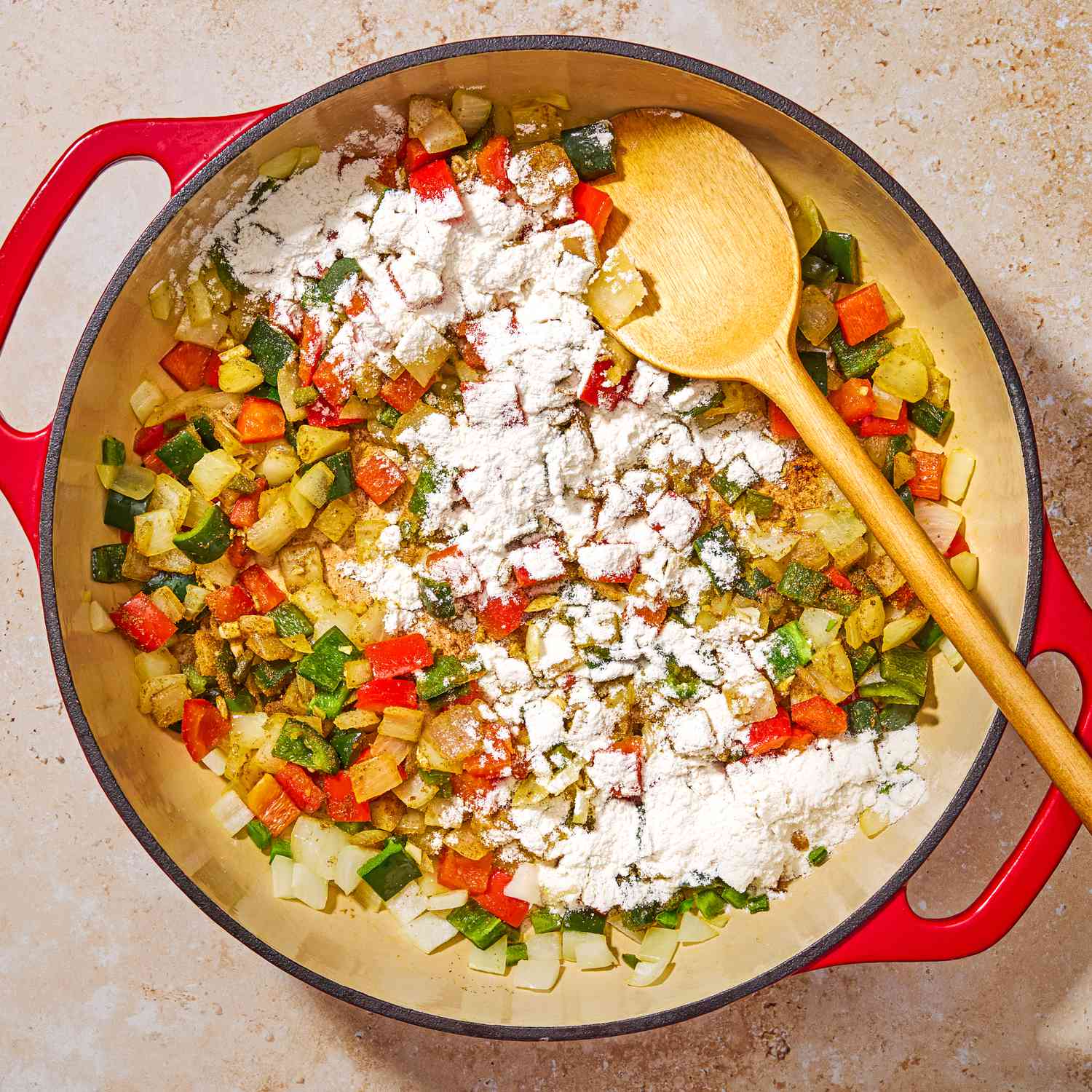 Photo of flour sprinkled over sautéed vegetables