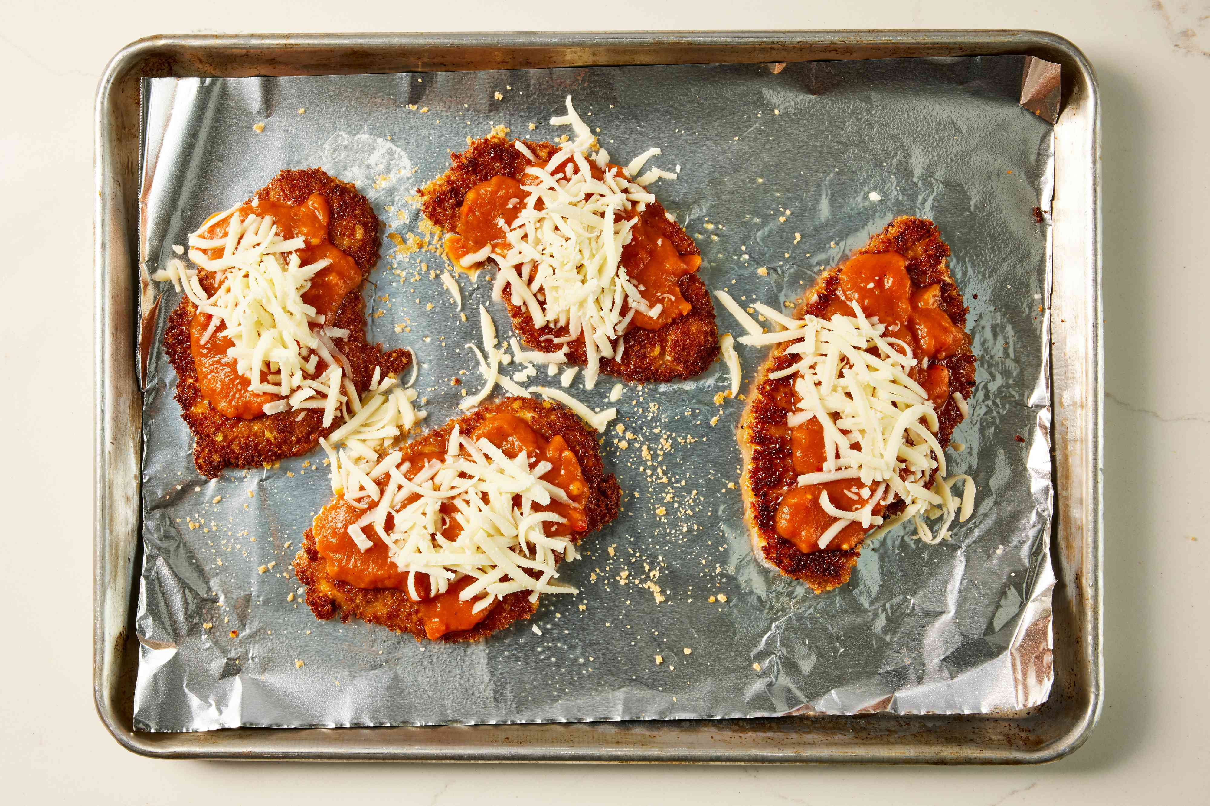 a step in making the Chicken Parmesan