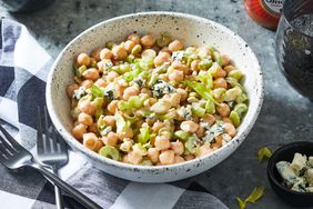Angled view of a rustic style bowl of Buffalo Chickpea Salad recipe