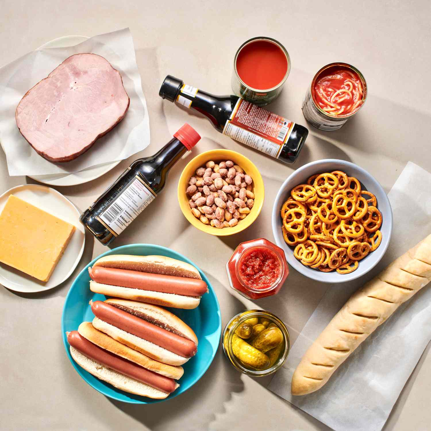 Various low-sodium food items arranged on a table, including bread, pretzels, hot dogs, and canned goods