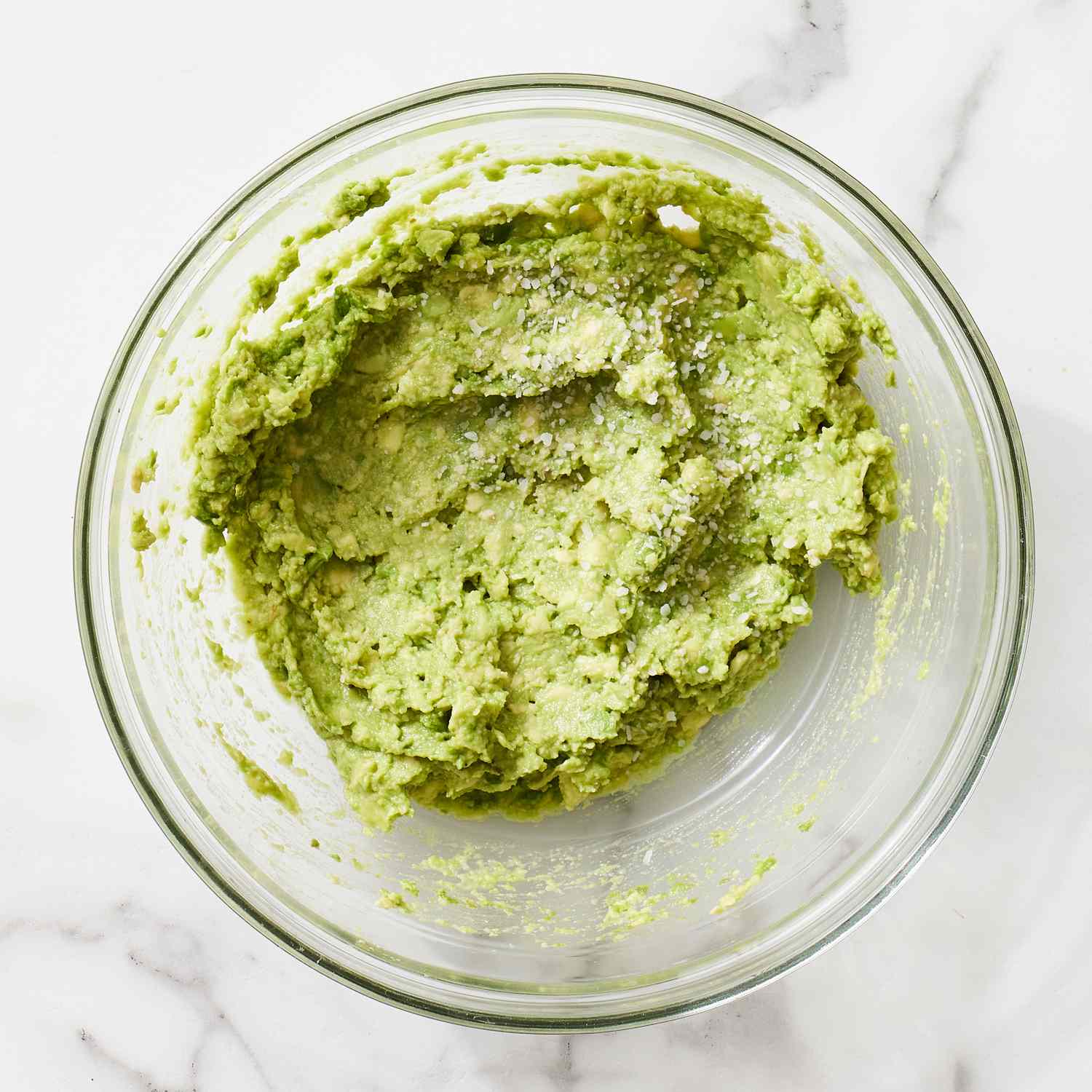 Freshly made guacamole in a clear bowl