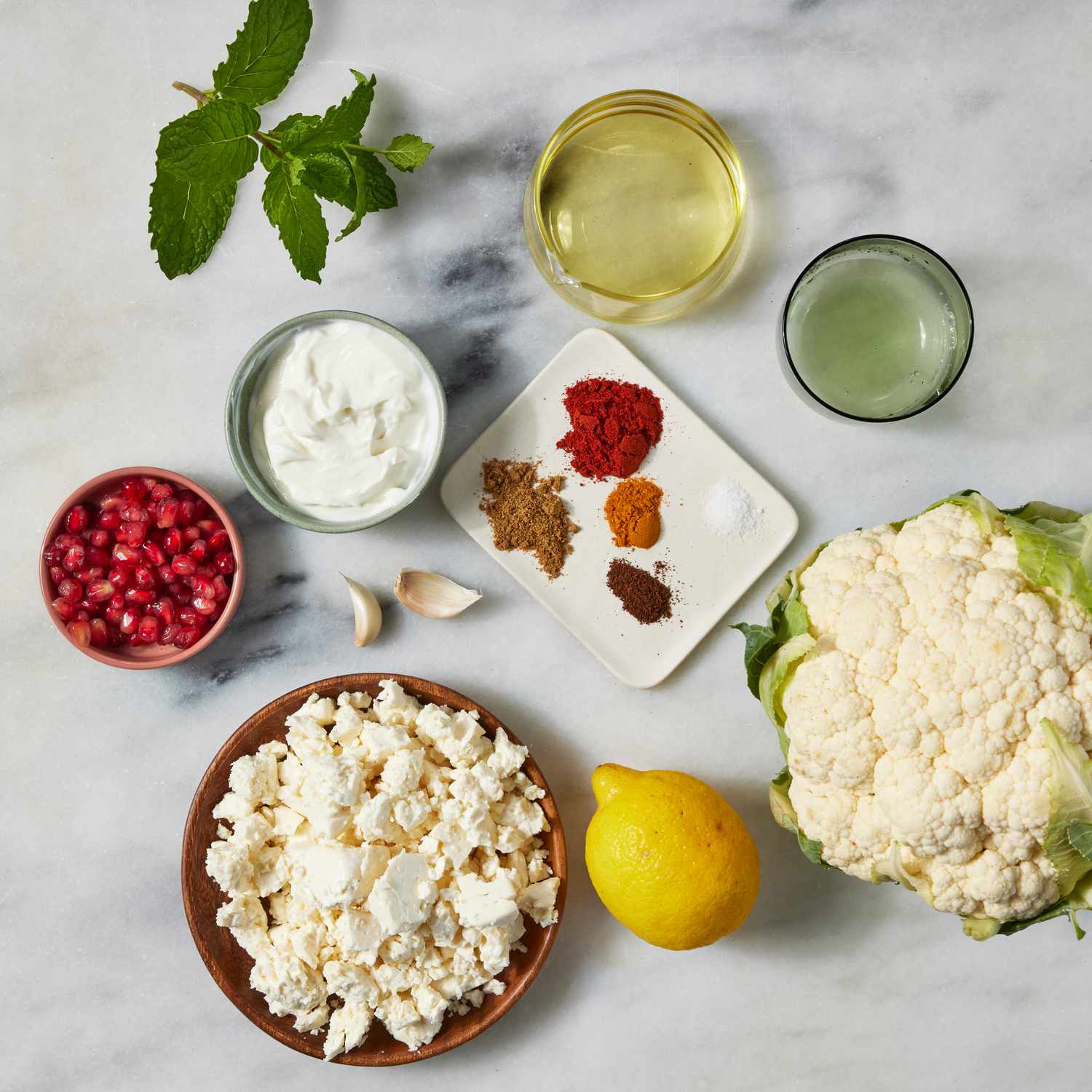 the ingredients to make the Whole Roasted Cauliflower with Whipped Feta & Pomegranate