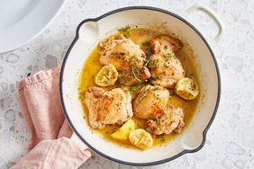 Four chicken thighs of the lemon-garlic boneless, skinless chicken thighs recipe, browned in a pan with oil and garlic and thyme in it