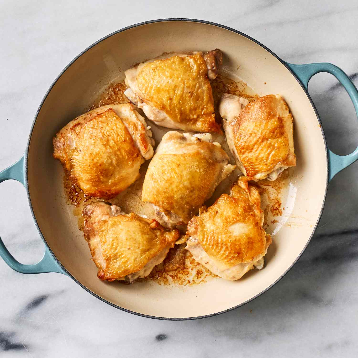 an image of the chicken thighs cooked in the skillet
