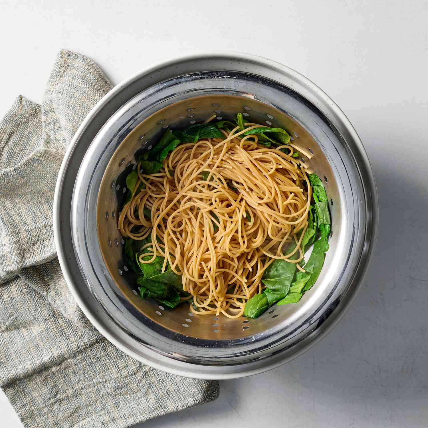 an image of the pasta and spinach in a strainer