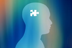 Silhouette of a head with a jigsaw puzzle piece symbolizing cognitive processes or mental health