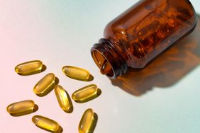 a photo of a bottle of capsules pouring out onto a surface