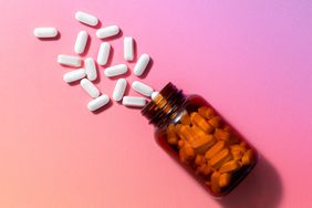 a photo of a bottle of pills spilled out onto a surface
