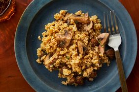 Mushroom rice recipe on a blue plate, with a fork on the fight side