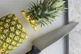 Pineapple on cutting board with knife