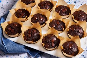 Chocolate muffins baked in a muffin tin, topped with chocolate chips