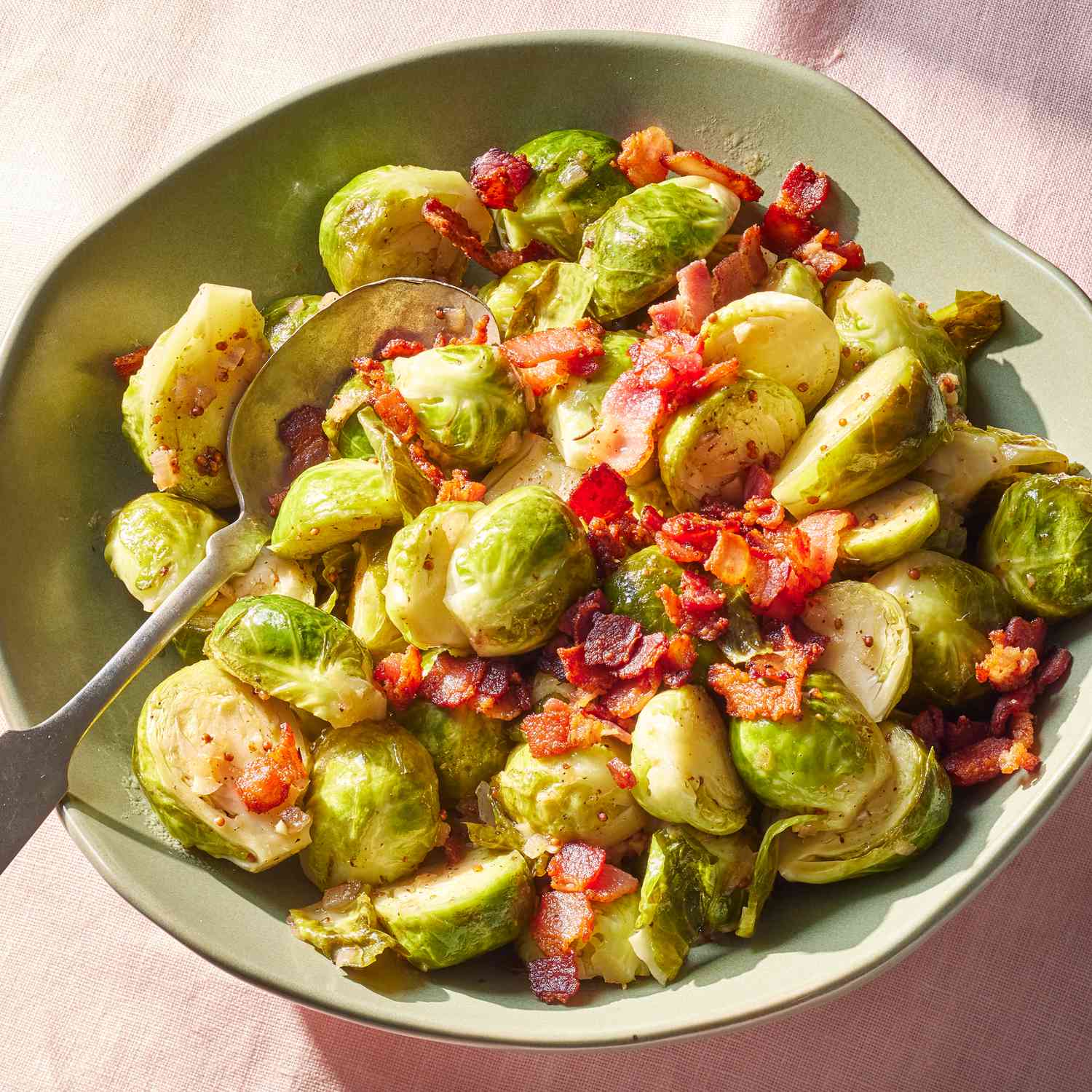 an overhead shot of the Brussels Sprouts with Bacon and Cider Vinegar in a green bowl
