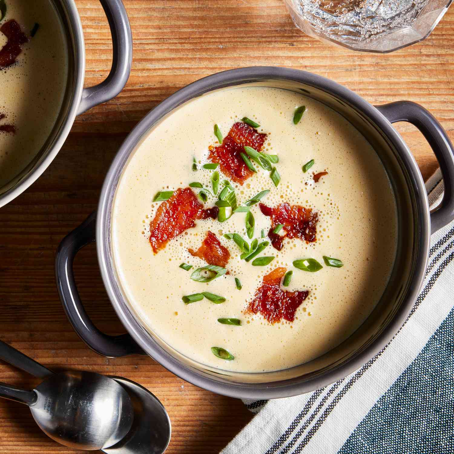a recipe photo of the Beer-Cheese Soup in a bowl with spoons beside it