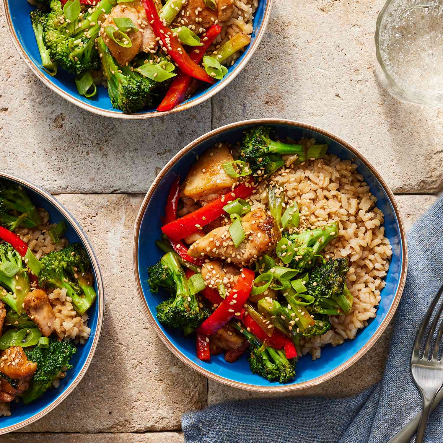 Overhead view of Teriyaki Chicken Rice Bowl, fork, and napkin