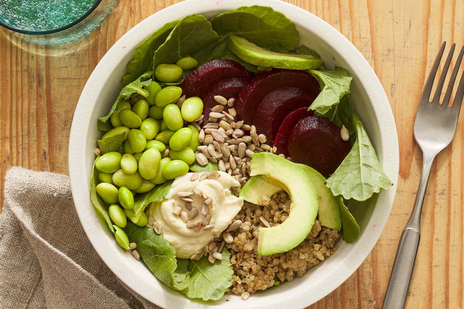 overhead shot of vegan grain bowl with edamame, beets and avocado