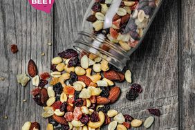 trail mix in mason jar on wooden background with the beet logo on top