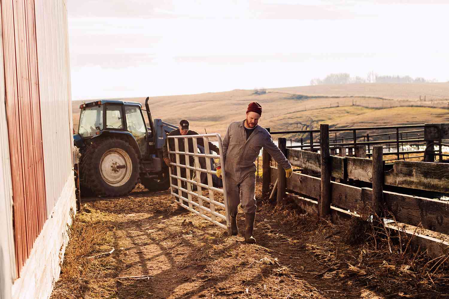 two men carrying a fence