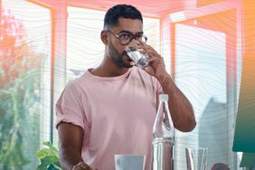a photo of a man drinking a glass of water