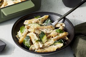 Angled view of a black plate of Creamy Zucchini & Rotisserie Chicken Pasta Bake recipe