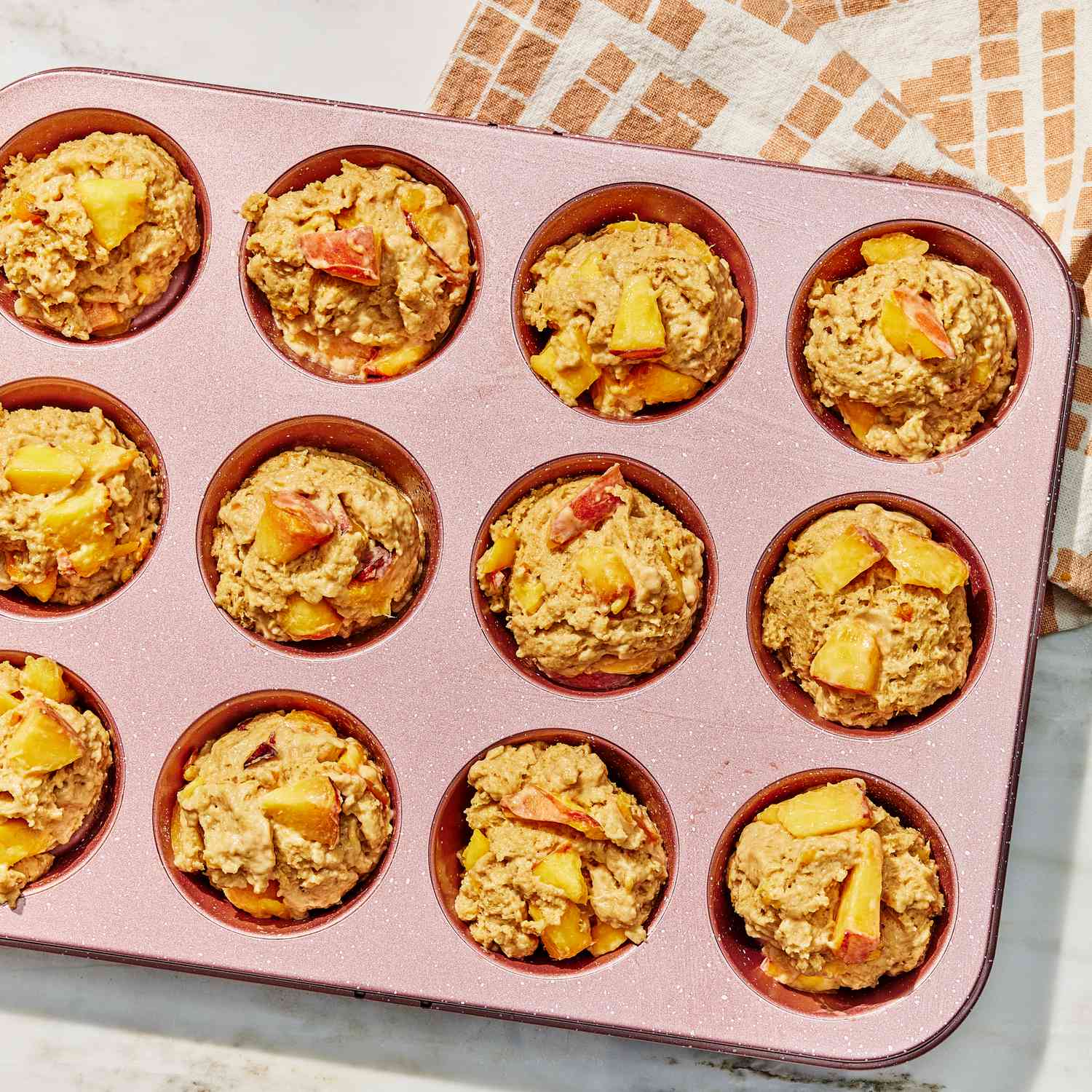 a photo of the mixture divided up into the muffin tin