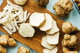 a photo of sunchokes chopped up and laying around a wooden cutting board