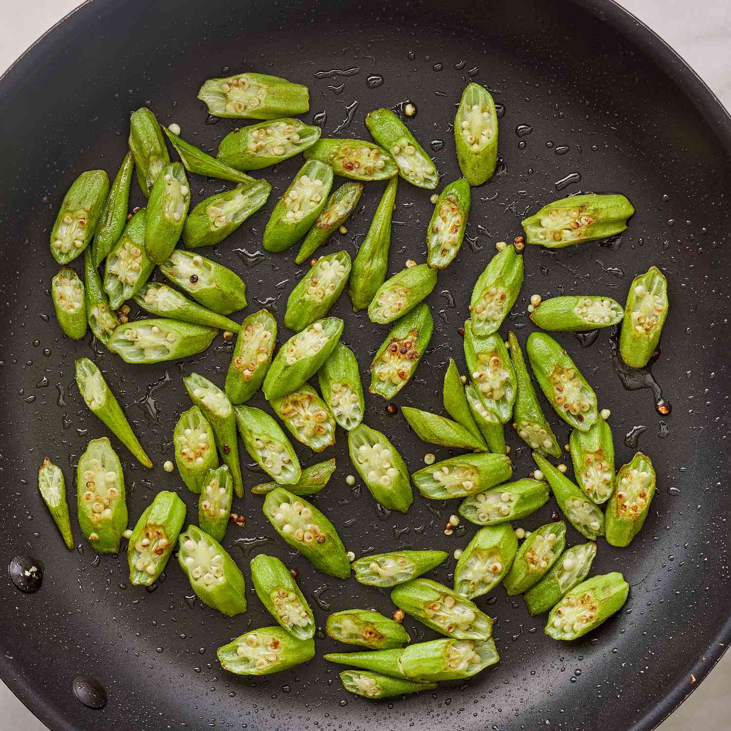 Sliced okra getting pan fried