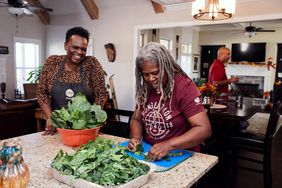 People cleaning collard greens