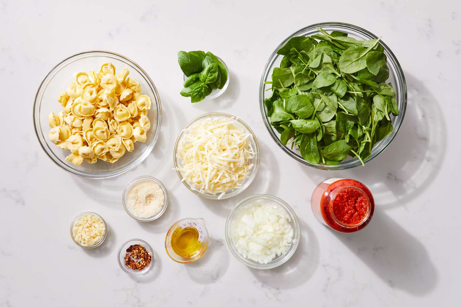 the ingredients to make the Spinach & Tortellini Casserole