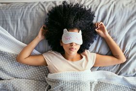 woman sleeping in bed with eye mask