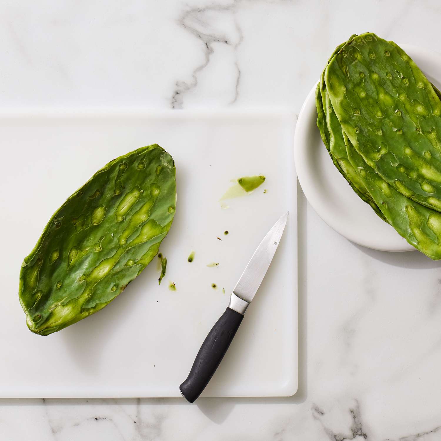 Cactus leaves having their spikes scraped of with a small chefs knife