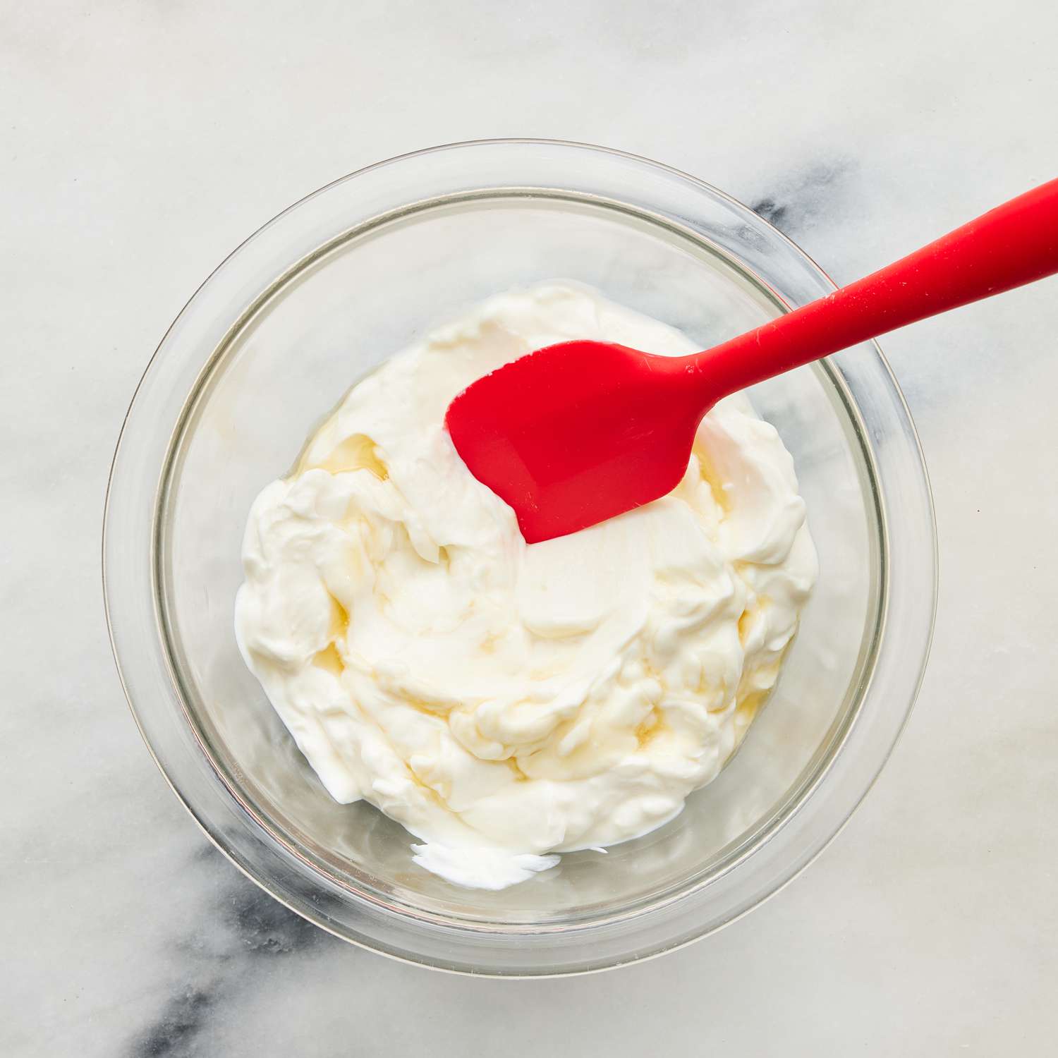 View from above of yogurt in a bowl with a spoon