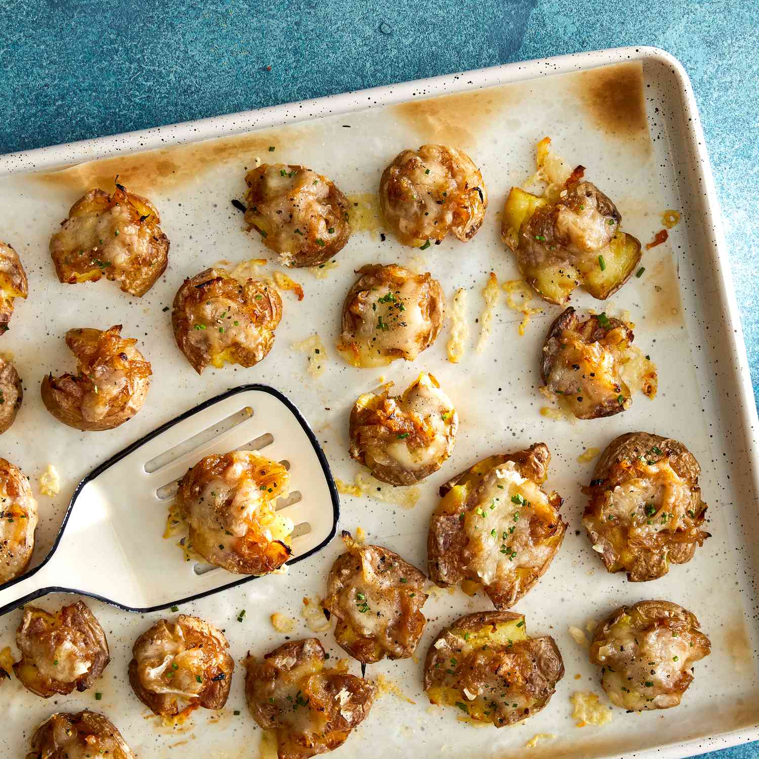 a recipe photo of the French Onion Smashed Potatoes on a cooking sheet
