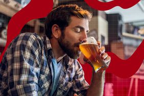 Man drinking a glass of beer in a casual setting