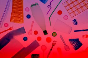 Various plastic utensils, bottle, containers, and straws arranged on a colored background