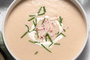 Overhead view of a white bowl of Creamy Radish Soup recipe