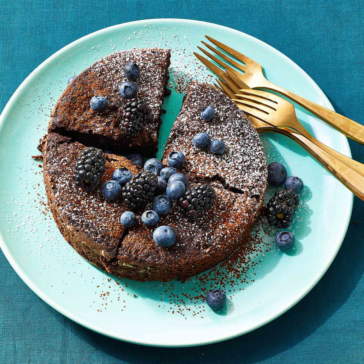 a recipe photo of the Air-Fryer Mini Dark Chocolate Cake served on a platter with forks