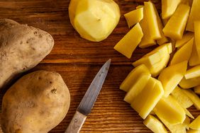 whole and sliced potatoes on cutting board