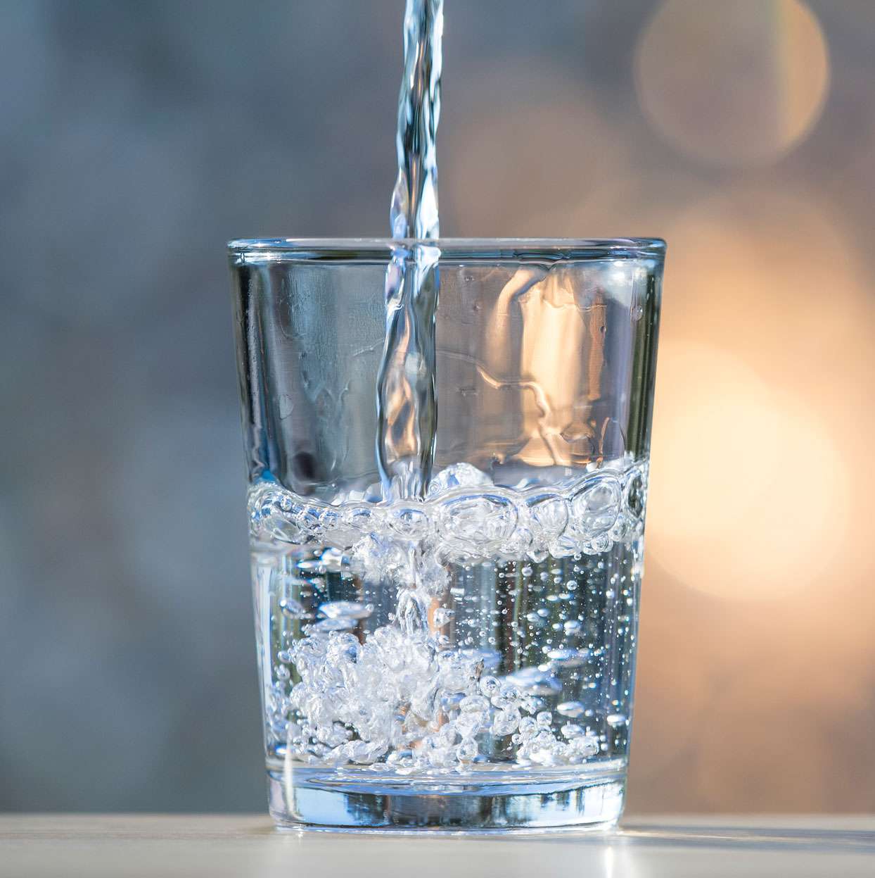 mineral water being poured into clear glass