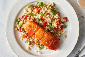 salmon with quinoa salad on a white plate