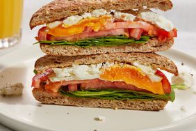 Egg Sandwich with Rosemary, Tomato & Feta sliced in half with slices stacked