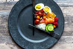 plate with knife and fork forming what looks like clock arms with food only within those arms (at 12:00 and 5:00)
