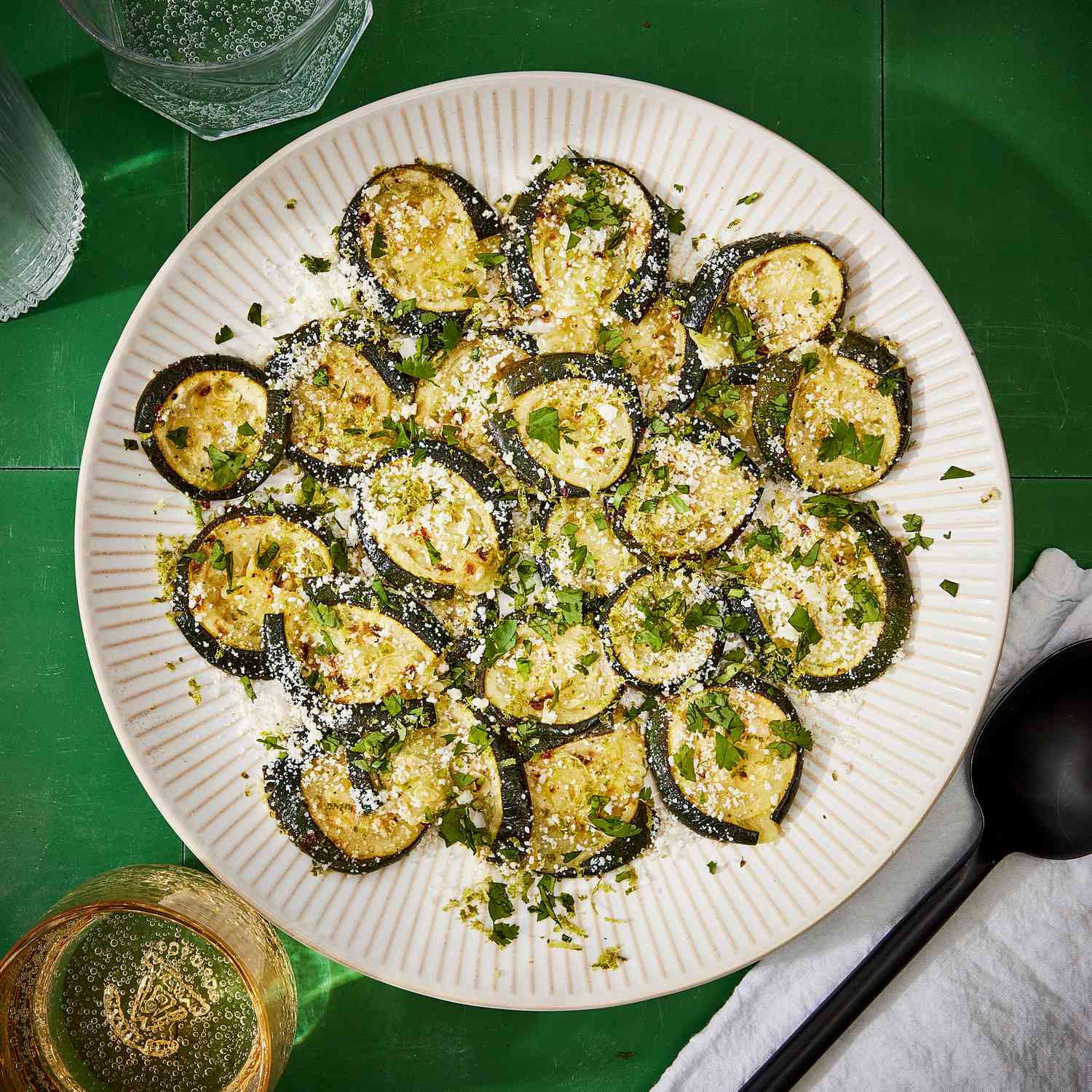 a recipe photo of the Smashed Zucchini with Lime, Cotija & Cilantro