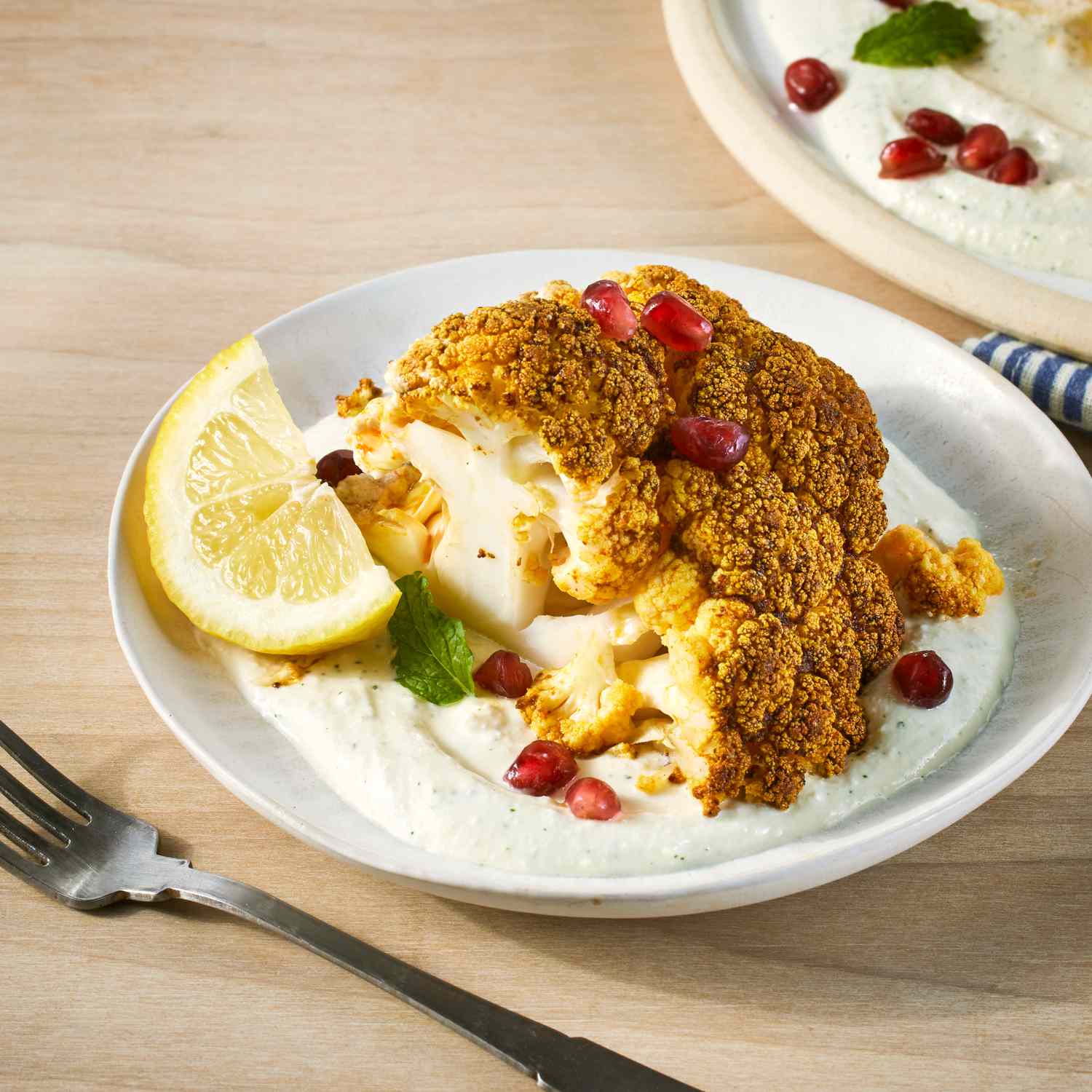 a recipe photo of the Whole Roasted Cauliflower with Whipped Feta & Pomegranate